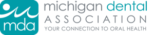 The image is a logo for the Michigan Dental Association, which includes text and graphic elements.
